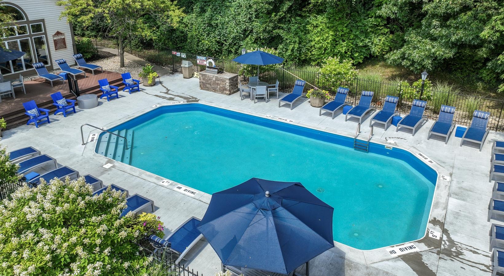 Shimmering resort-style pool a pool with chairs around it