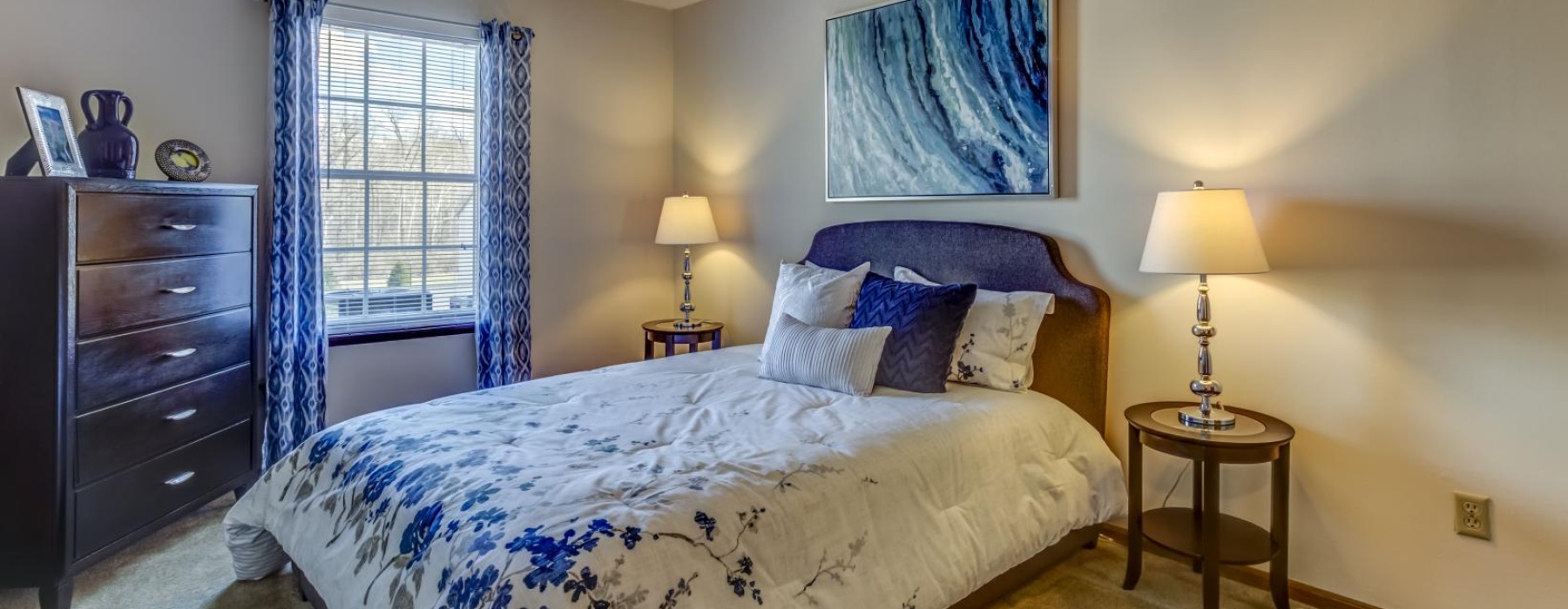 a bedroom with a bed and lamps