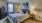 a bedroom with a bed and lamps
