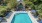 a pool with chairs around it