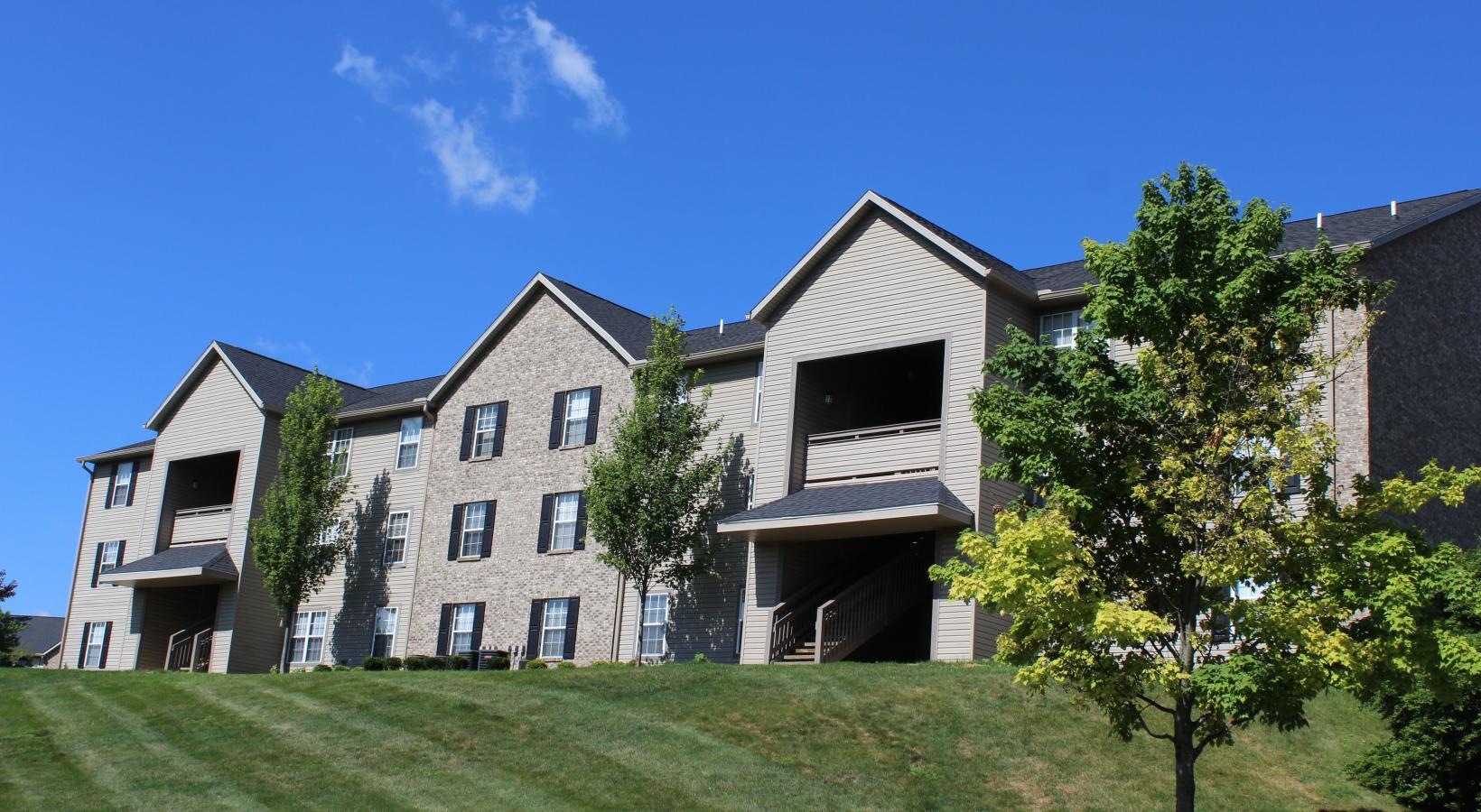 The essence of exceptional living a large building with trees in front of it