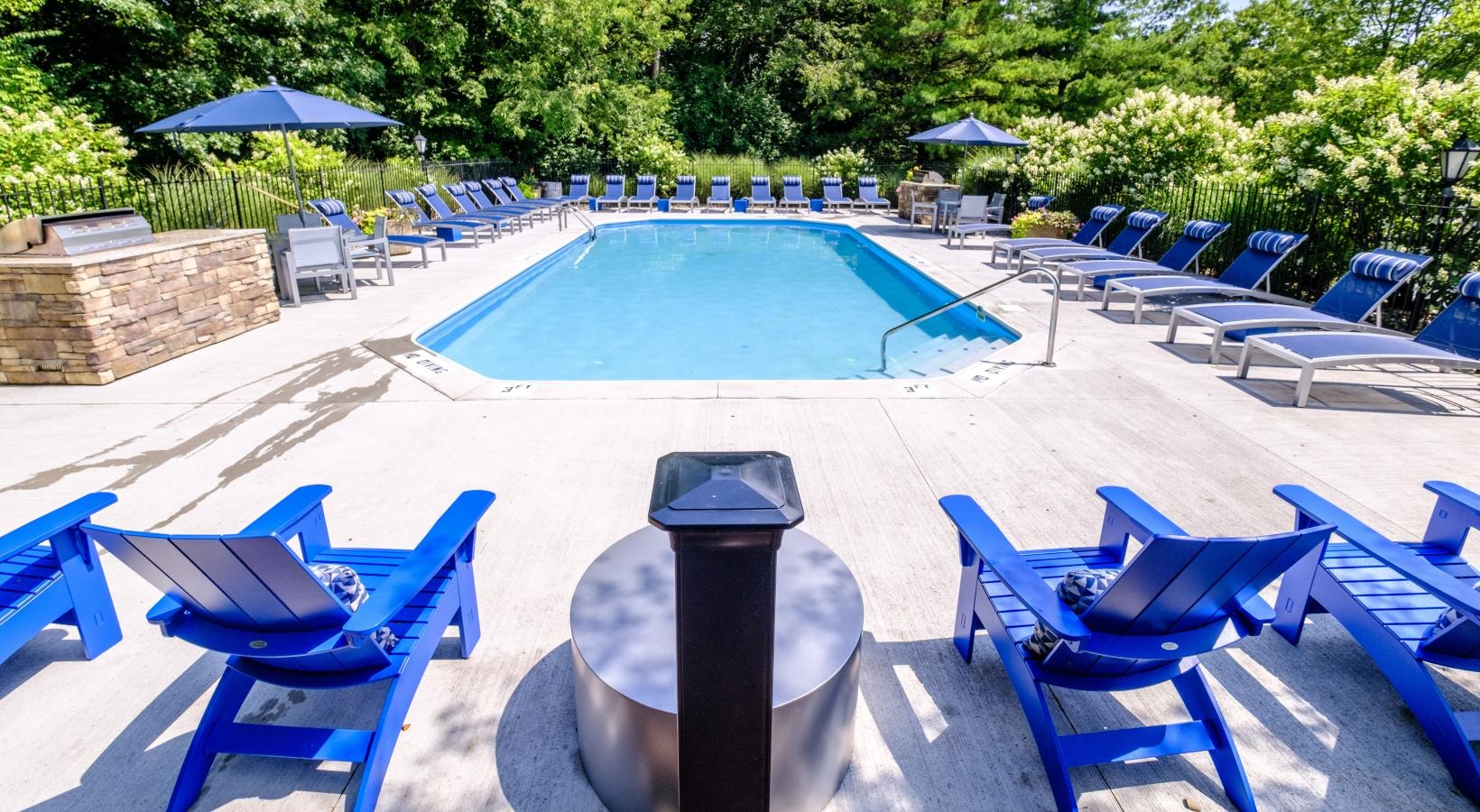 The essence of exceptional living a pool with chairs around it